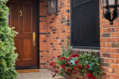 Mid-sized elegant concrete floor, brown floor, wood ceiling and brick wall entryway photo in Seattle with a medium wood front door