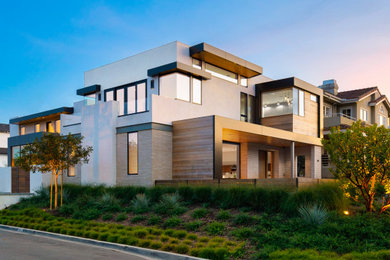 Inspiration for a large contemporary two-storey stucco house exterior in Orange County.