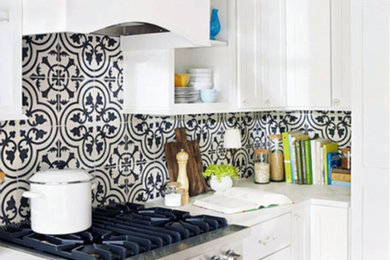 Mid-sized trendy medium tone wood floor and brown floor kitchen photo in Other with shaker cabinets, white cabinets, quartz countertops, multicolored backsplash, cement tile backsplash, stainless steel appliances and white countertops