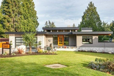 Inspiration for a mid-sized contemporary beige two-story mixed siding exterior home remodel in Vancouver