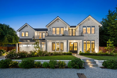 Example of a large transitional white two-story brick exterior home design in Seattle with a mixed material roof and a black roof