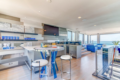 Large minimalist open concept light wood floor and brown floor family room photo in Chicago with a bar, white walls, no fireplace and a wall-mounted tv