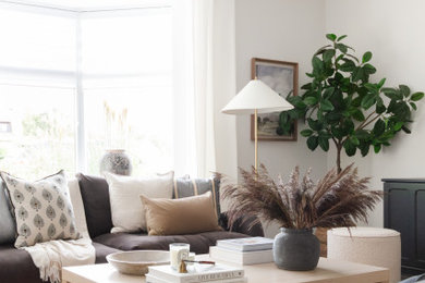 This is an example of a large classic open plan living room curtain in Other with white walls, ceramic flooring, a corner fireplace, a freestanding tv and black floors.
