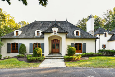 Example of a french country exterior home design in DC Metro