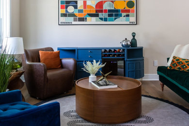 Example of a large eclectic open concept medium tone wood floor and brown floor living room design in New York with a bar, yellow walls, no fireplace and a concealed tv