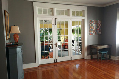Living room - mid-sized transitional enclosed medium tone wood floor and brown floor living room idea in Charlotte with gray walls, no fireplace and no tv