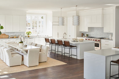 Kitchen - transitional l-shaped dark wood floor and brown floor kitchen idea in Los Angeles with shaker cabinets, white cabinets, gray backsplash, marble backsplash, stainless steel appliances, an island and white countertops