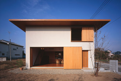 Inspiration for an asian two-storey white exterior in Other.