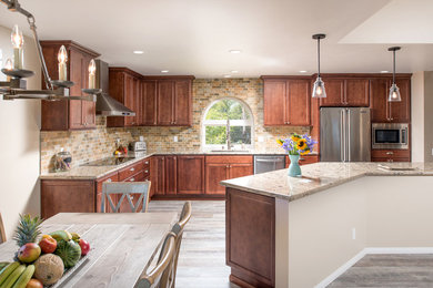 Inspiration for a large contemporary l-shaped light wood floor open concept kitchen remodel in San Diego with a drop-in sink, recessed-panel cabinets, brown cabinets, granite countertops, multicolored backsplash, ceramic backsplash, stainless steel appliances and an island
