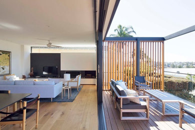 Mid-sized contemporary balcony in Sydney with no cover and glass railing.
