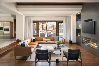 Inspiration for a modern open concept medium tone wood floor and wood ceiling living room remodel in Denver with a ribbon fireplace, a concrete fireplace and a wall-mounted tv