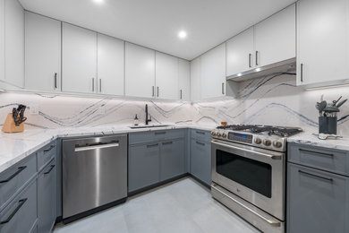 Mid-sized trendy u-shaped kitchen photo in New York with gray cabinets, quartz countertops, white backsplash, stainless steel appliances and white countertops