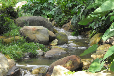 Inspiration for a large mediterranean partial sun backyard water fountain landscape in Santa Barbara.