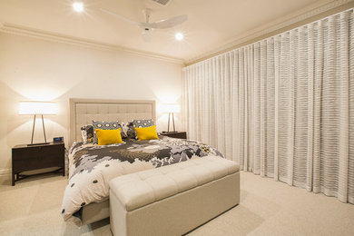 This is an example of a small contemporary master bedroom in Adelaide with beige walls, carpet and no fireplace.