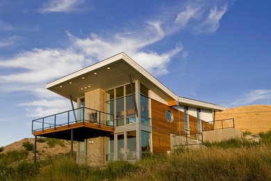 Mid-sized contemporary two-story mixed siding exterior home idea in Calgary