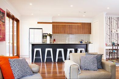 Design ideas for a large contemporary galley open plan kitchen in Brisbane with cement tile splashback, dark hardwood floors, with island, white benchtop, a drop-in sink, stainless steel appliances and brown floor.