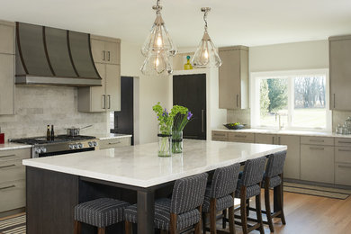 Large transitional l-shaped light wood floor and brown floor kitchen photo in Grand Rapids with an undermount sink, flat-panel cabinets, quartzite countertops, an island, gray cabinets, gray backsplash, stainless steel appliances, white countertops and stone tile backsplash