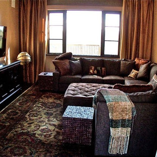 Tuscan home theater photo in San Luis Obispo with a wall-mounted tv and brown walls