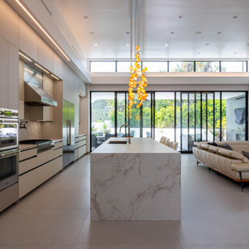 Glass Lighting Anchoring a Double-Height Open Interior