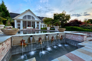 Photo of a huge traditional shade backyard brick water fountain landscape in Other.