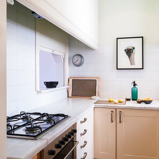 Small eclectic kitchen pantry ideas - Small eclectic u-shaped kitchen pantry photo in Barcelona with a drop-in sink, marble countertops, white backsplash, ceramic backsplash, stainless steel appliances, raised-panel cabinets, beige cabinets and no island