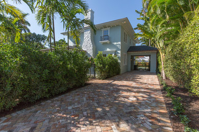 Inspiration for a mediterranean green two-story stucco exterior home remodel in Miami