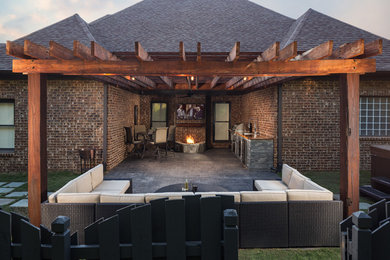 Mid-sized country backyard patio in Birmingham with an outdoor kitchen, stamped concrete and a pergola.