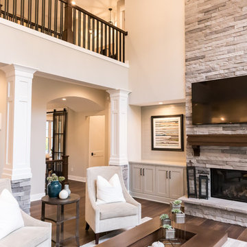 Living Room Remodel Featuring a Ledgestone Fireplace + Cabinetry + Shaw Coretec