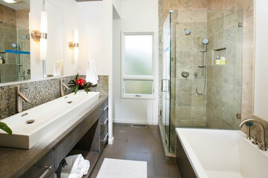 This is an example of a mid-sized contemporary master bathroom in San Francisco with a drop-in tub, a corner shower, white walls, ceramic floors, a trough sink, brown floor, a hinged shower door, flat-panel cabinets, dark wood cabinets, beige tile, ceramic tile and concrete benchtops.
