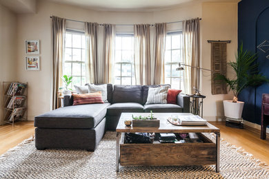 Small eclectic enclosed light wood floor living room photo in San Francisco with white walls, a standard fireplace, a wood fireplace surround and a wall-mounted tv