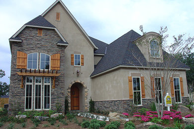 Inspiration for a large craftsman beige two-story mixed siding exterior home remodel in Miami with a shingle roof