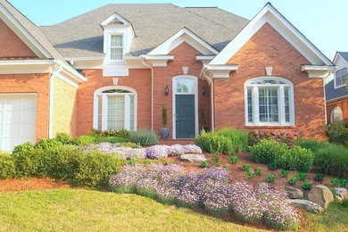 Inspiration for a small traditional front yard full sun xeriscape for spring in Atlanta with a garden path.