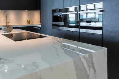 Photo of a contemporary kitchen in Miami with quartz benchtops and with island.