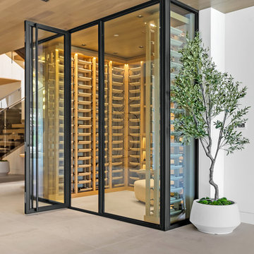 Cream Leather Wine Saddles and Walnut Cabinetry with Metal Rods in Dana Point