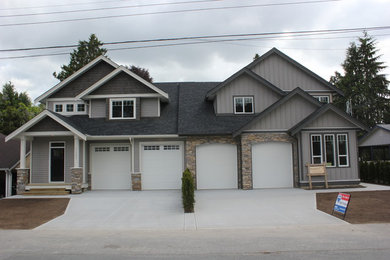 Mid-sized elegant gray two-story vinyl gable roof photo in Vancouver