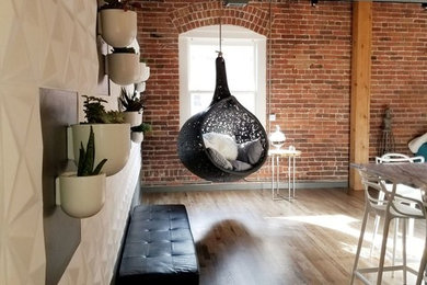 Kitchen - mid-sized eclectic u-shaped medium tone wood floor and gray floor kitchen idea in Denver with a farmhouse sink, flat-panel cabinets, gray cabinets, soapstone countertops, black backsplash, ceramic backsplash, stainless steel appliances and an island