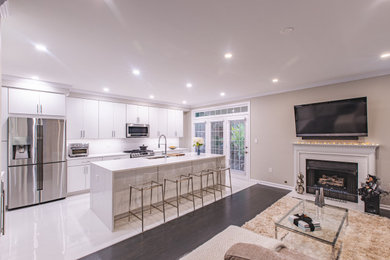 Trendy eat-in kitchen photo in DC Metro with a drop-in sink, beige backsplash, stainless steel appliances, two islands and white countertops