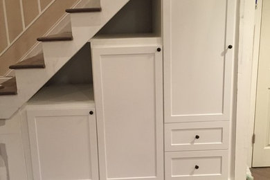 Mid-sized elegant wooden straight wood railing staircase photo in New York with painted risers