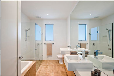 Design ideas for a large modern master bathroom in Adelaide with medium wood cabinets, a drop-in tub, an alcove shower, white tile, ceramic tile, travertine floors, quartzite benchtops, brown floor and a hinged shower door.