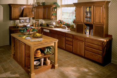 Design ideas for a mid-sized traditional l-shaped kitchen pantry in Other with medium wood cabinets, a double-bowl sink, shaker cabinets, stainless steel appliances, ceramic floors, no island and brown floor.