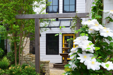 Inspiration for a mid-sized traditional partial sun backyard stone landscaping in Seattle.