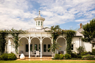 Example of a huge ornate white one-story wood gable roof design in Houston with a gray roof