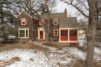Inspiration for a timeless two-story wood and shingle house exterior remodel in Minneapolis