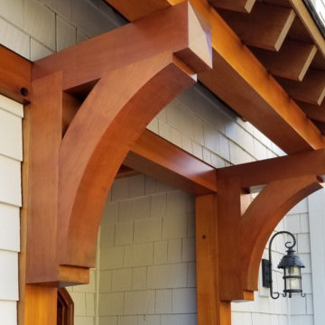 Exterior makeover with stained cedar shake siding and wood accents