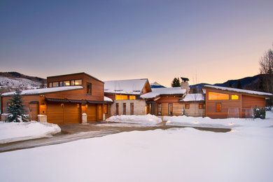 Country two-storey exterior in Denver with wood siding.