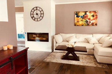 Mid-sized trendy formal and open concept dark wood floor and brown floor living room photo in Cleveland with gray walls, a standard fireplace and no tv