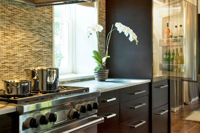 Mid-sized transitional l-shaped dark wood floor and brown floor open concept kitchen photo in New York with flat-panel cabinets, dark wood cabinets, multicolored backsplash, matchstick tile backsplash, stainless steel appliances and an island