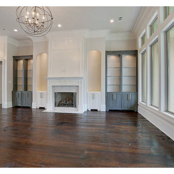 Huge family room with custom lighting and a wall of windows.