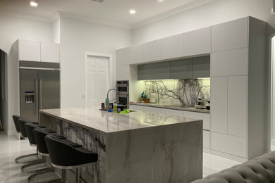 Inspiration for a mid-sized modern kitchen remodel in Miami with flat-panel cabinets, gray cabinets and an island
