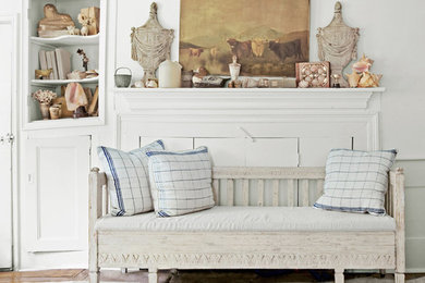 Cottage chic light wood floor bedroom photo in New York with white walls and a wood fireplace surround